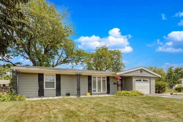 337 E Clark St, Glenwood, IL 60425 - single story home featuring a garage, concrete driveway, and a front lawn