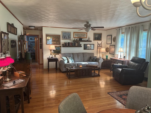 1202 E Van Buren St, Clinton, IL 61727 - living room with ceiling fan, a textured ceiling, hardwood / wood-style floors, and crown molding