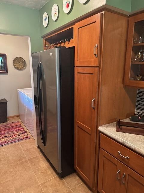 1202 E Van Buren St, Clinton, IL 61727 - kitchen with refrigerator with ice dispenser, brown cabinetry, and light countertops