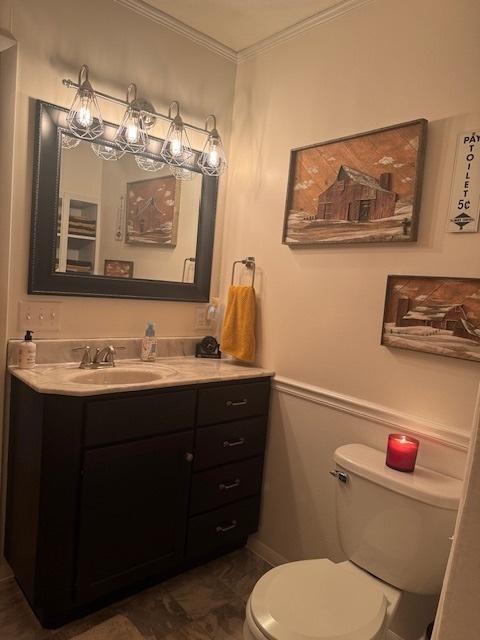 1202 E Van Buren St, Clinton, IL 61727 - half bathroom featuring vanity, crown molding, and wainscoting