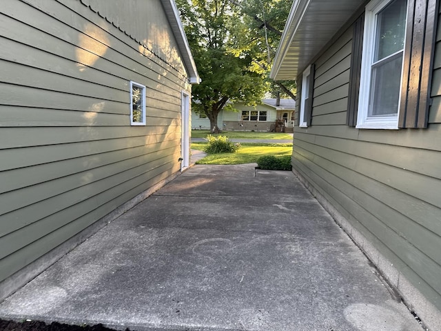 1202 E Van Buren St, Clinton, IL 61727 - view of side of home featuring a patio