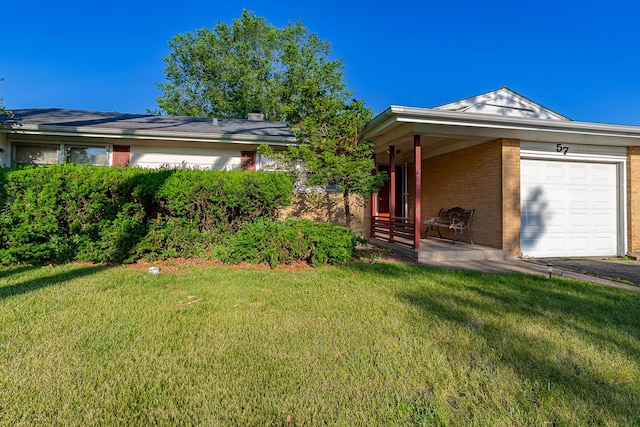 57 Forest Ln, Elk Grove Village, IL 60007 - view of front of home with a front lawn, brick siding, an attached garage, and covered porch