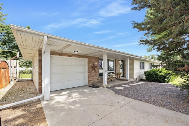1110 N Main St, Normal, IL 61761 - single story home with concrete driveway, brick siding, an attached garage, a porch, and a gate
