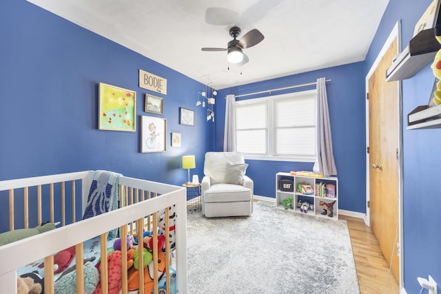 1110 N Main St, Normal, IL 61761 - bedroom with wood finished floors, a nursery area, and ceiling fan