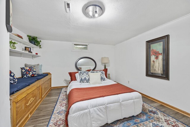 1110 N Main St, Normal, IL 61761 - bedroom featuring wood finished floors and a textured ceiling