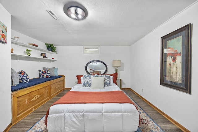 1110 N Main St, Normal, IL 61761 - bedroom with wood finished floors and a textured ceiling