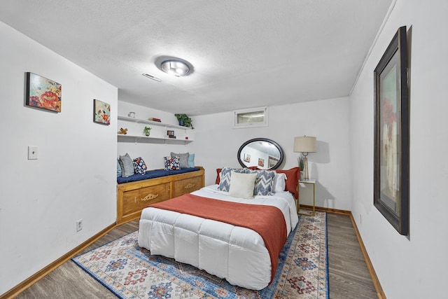 1110 N Main St, Normal, IL 61761 - bedroom with wood finished floors and a textured ceiling