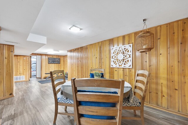 1110 N Main St, Normal, IL 61761 - dining area with wooden walls and light wood-style floors