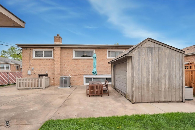 4839 Lamb Dr, Oak Lawn, IL 60453 - back of house featuring a chimney, an outbuilding, a patio, brick siding, and a garage