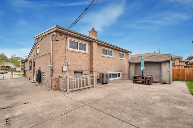 4839 Lamb Dr, Oak Lawn, IL 60453 - rear view of property with a chimney, a patio, brick siding, and an outbuilding