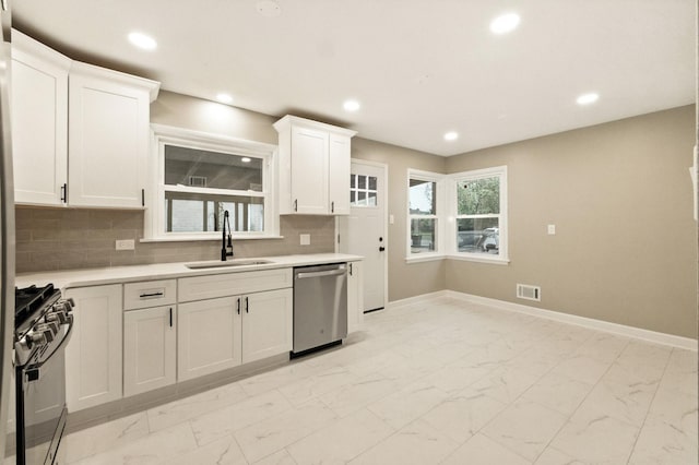 4506 W 77th Pl, Chicago, IL 60652 - kitchen featuring dishwasher, gas range, light marble finish floors, light countertops, and recessed lighting