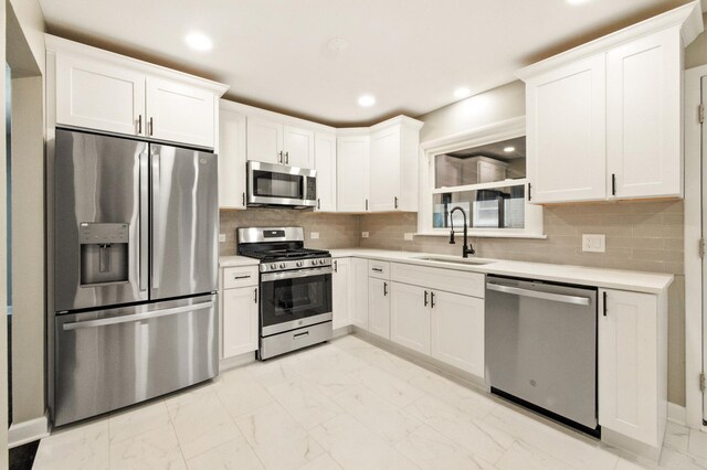 4506 W 77th Pl, Chicago, IL 60652 - kitchen featuring appliances with stainless steel finishes, light marble finish flooring, light countertops, white cabinetry, and recessed lighting