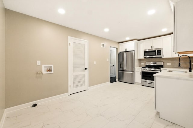 4506 W 77th Pl, Chicago, IL 60652 - kitchen with stainless steel appliances, light marble finish flooring, recessed lighting, light countertops, and white cabinets