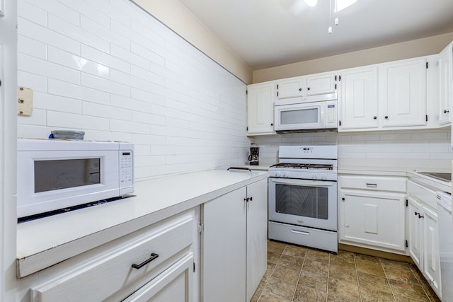 945 E Kenilworth Ave Unit 120, Palatine, IL 60074 - kitchen with white appliances, white cabinetry, light countertops, and stone finish floors