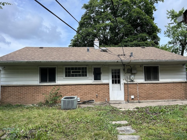 417 Shabbona Dr, Park Forest, IL 60466 - back of house featuring brick siding, a shingled roof, and a chimney