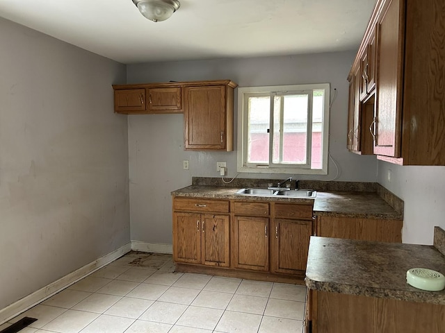 417 Shabbona Dr, Park Forest, IL 60466 - kitchen featuring brown cabinets, dark countertops, and light tile patterned flooring