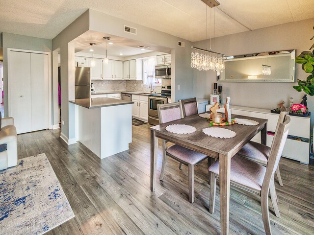 1215 Chalet Rd Unit 200, Naperville, IL 60563 - dining room featuring wood finished floors and a chandelier