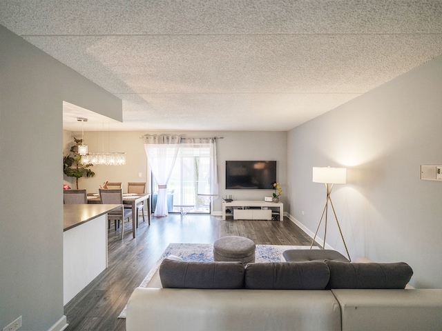 1215 Chalet Rd Unit 200, Naperville, IL 60563 - living room featuring dark wood-type flooring, a chandelier, and a textured ceiling