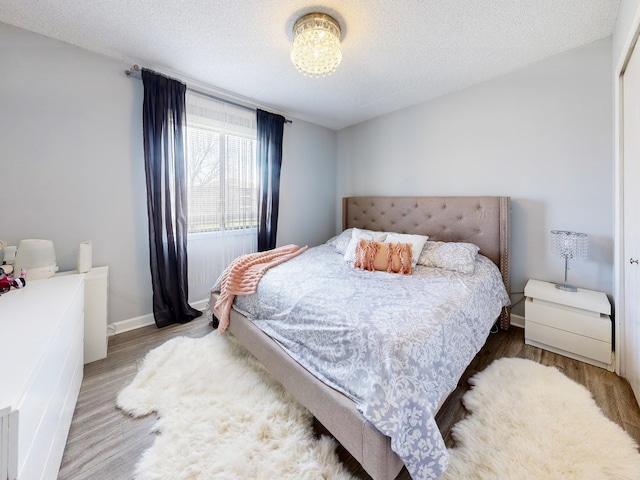 1215 Chalet Rd Unit 200, Naperville, IL 60563 - bedroom featuring wood finished floors and a textured ceiling