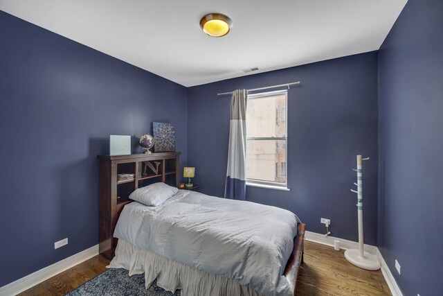 5017 S Prairie Ave Unit 2N, Chicago, IL 60615 - bedroom featuring baseboards and wood finished floors
