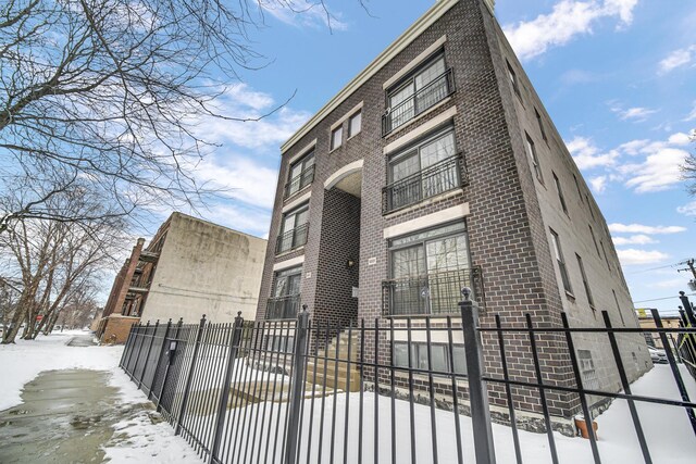 5017 S Prairie Ave Unit 2N, Chicago, IL 60615 - snow covered property with a fenced front yard