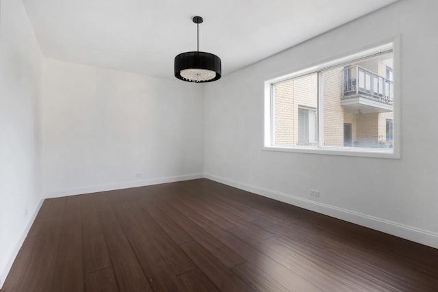 5251 W Galitz St Unit 311, Skokie, IL 60077 - spare room featuring dark wood-style flooring and baseboards