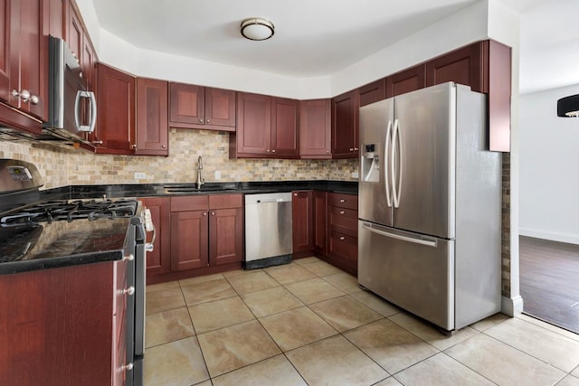 5251 W Galitz St Unit 311, Skokie, IL 60077 - kitchen featuring appliances with stainless steel finishes, dark countertops, reddish brown cabinets, decorative backsplash, and light tile patterned floors