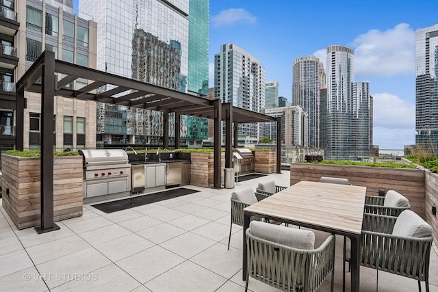 435 N Michigan Ave Unit 1203, Chicago, IL 60611 - view of patio / terrace featuring an outdoor kitchen, a view of skyline, and outdoor dining area