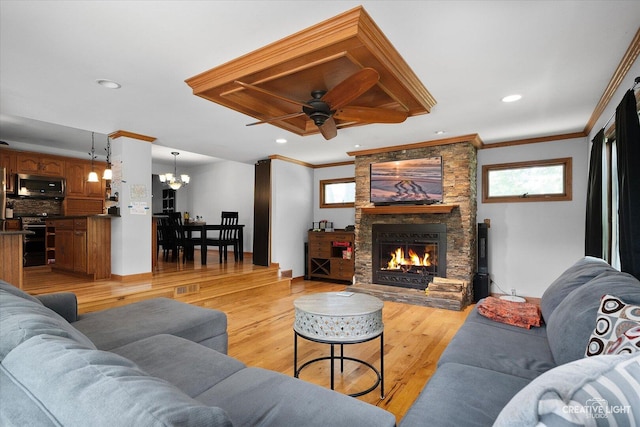 1920 Heather Ln, Joliet, IL 60431 - living room featuring healthy amount of natural light, a chandelier, a stone fireplace, crown molding, and a ceiling fan