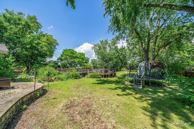 1920 Heather Ln, Joliet, IL 60431 - view of yard with a trampoline, a wooden deck, and view of scattered trees