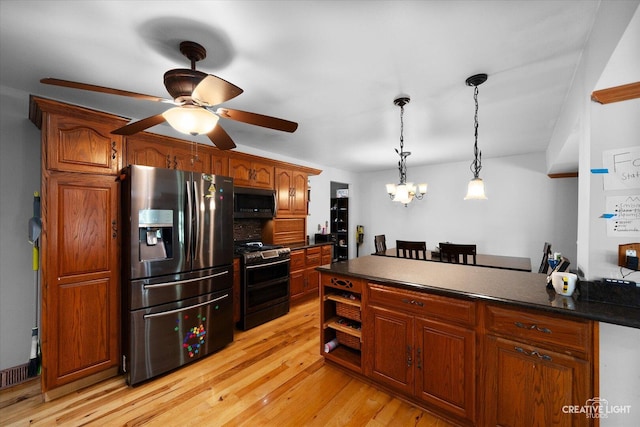 1920 Heather Ln, Joliet, IL 60431 - kitchen with appliances with stainless steel finishes, dark countertops, ceiling fan, pendant lighting, and a chandelier