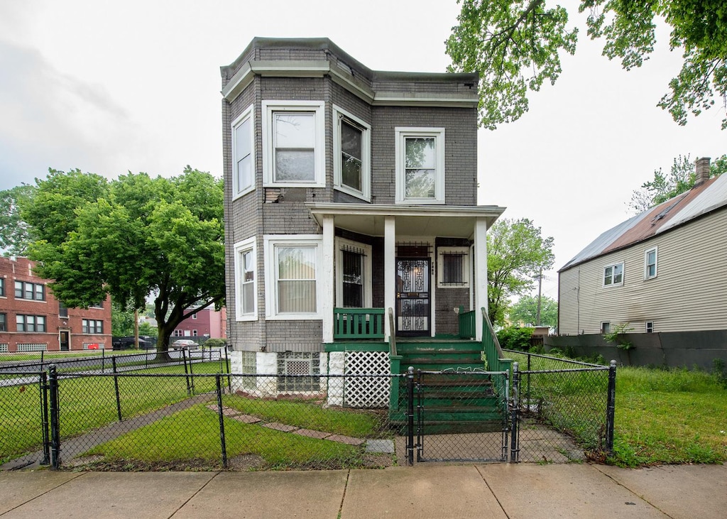 7256 S May St, Chicago, IL 60621 - view of front facade with covered porch, a gate, a fenced front yard, and brick siding