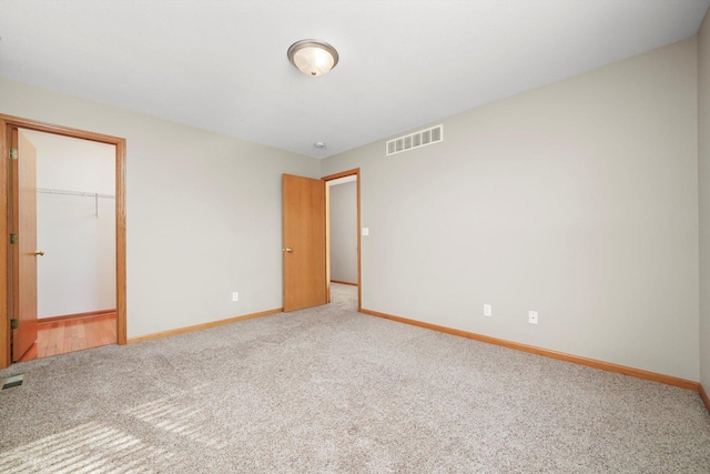 1225 Alexandria Dr, Sycamore, IL 60178 - unfurnished bedroom with carpet, a closet, and a spacious closet