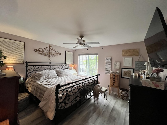 bedroom with wood finished floors and a ceiling fan