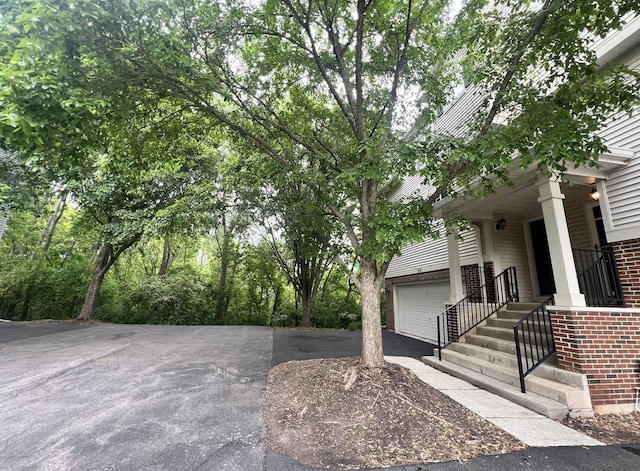surrounding community with driveway and a garage
