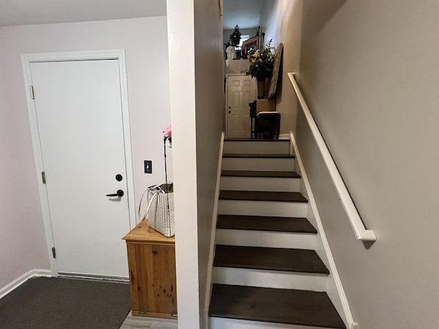 stairway featuring baseboards