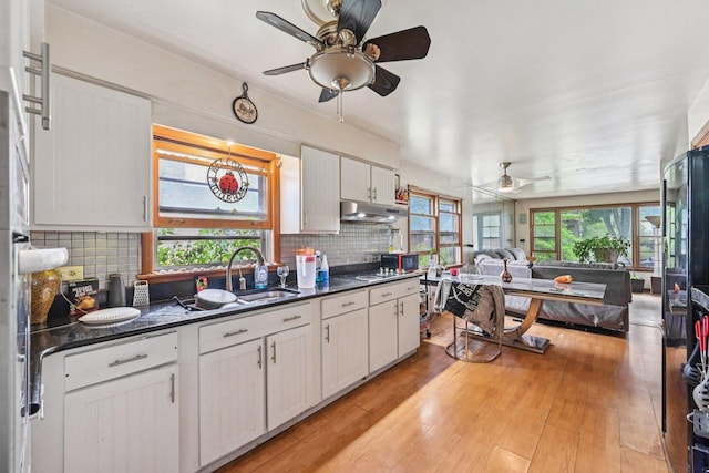 626 E 90th St, Chicago, IL 60619 - kitchen with a ceiling fan, dark countertops, open floor plan, tasteful backsplash, and light wood finished floors