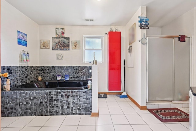 626 E 90th St, Chicago, IL 60619 - full bath with tile patterned floors, a shower stall, and tiled bath