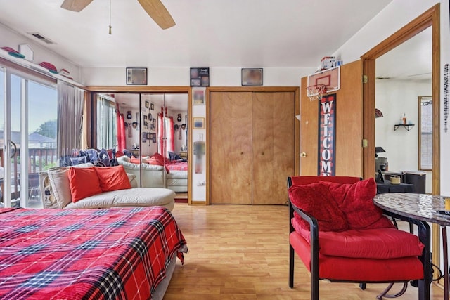 626 E 90th St, Chicago, IL 60619 - bedroom featuring wood finished floors, access to exterior, a ceiling fan, and two closets