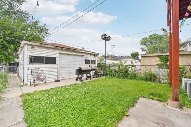 626 E 90th St, Chicago, IL 60619 - view of yard featuring a detached garage and an outdoor structure