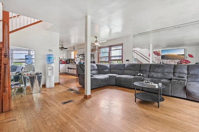 626 E 90th St, Chicago, IL 60619 - living area with a ceiling fan, light wood-type flooring, and stairs