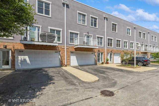 49 W 15th St Unit D, Chicago, IL 60605 - view of building exterior with driveway and an attached garage