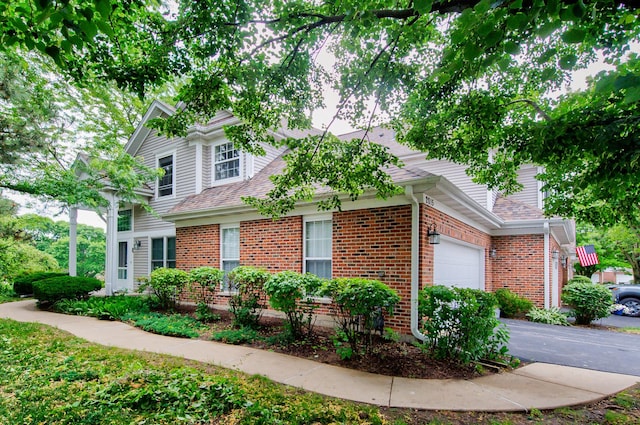 2015 N Silver Lake Rd Unit 1, Arlington Heights, IL 60004 - view of front of house featuring an attached garage, brick siding, and a shingled roof