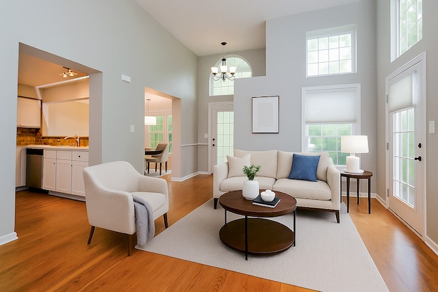 2015 N Silver Lake Rd Unit 1, Arlington Heights, IL 60004 - living room with a high ceiling, light wood finished floors, a chandelier, and plenty of natural light
