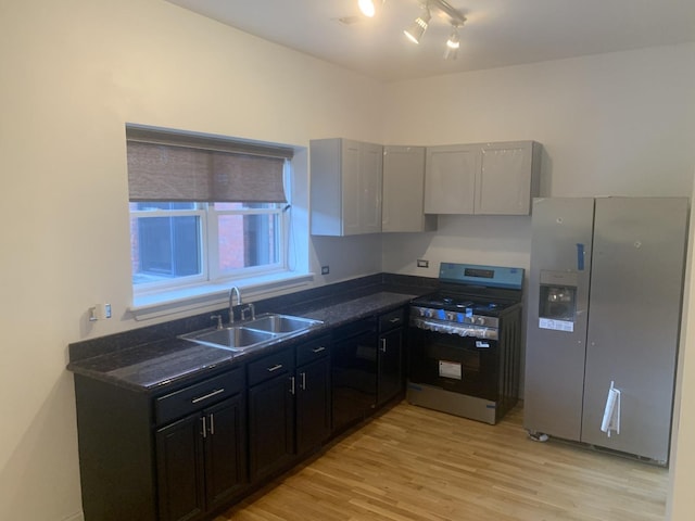5940 S King Dr Unit 4W, Chicago, IL 60637 - kitchen with appliances with stainless steel finishes, dark countertops, light wood-style floors, and rail lighting