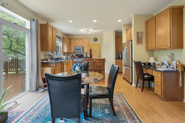 910 Angle Tarn Dr, West Dundee, IL 60118 - kitchen with appliances with stainless steel finishes, dark countertops, light wood-type flooring, and recessed lighting