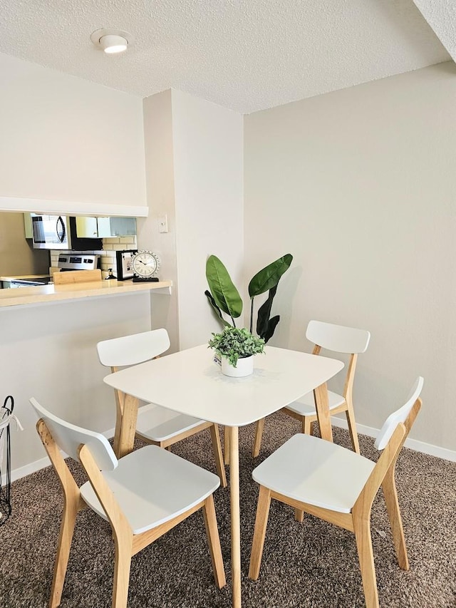 1166 Pomona Dr, Champaign, IL 61822 - dining area with carpet floors and a textured ceiling