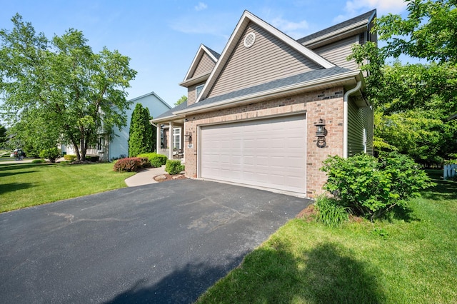 1826 Joseph Sixbury St, Sycamore, IL 60178 - view of front of property with brick siding, driveway, a garage, and a front lawn