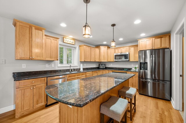 1826 Joseph Sixbury St, Sycamore, IL 60178 - kitchen with stainless steel appliances, light wood-style flooring, a breakfast bar area, recessed lighting, and a center island