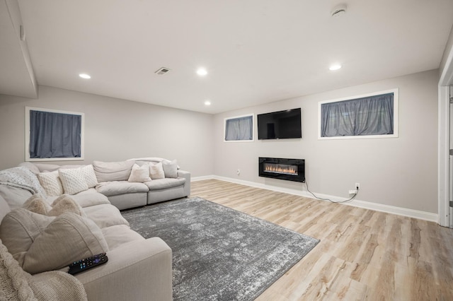 1826 Joseph Sixbury St, Sycamore, IL 60178 - living area with wood finished floors, a glass covered fireplace, and recessed lighting
